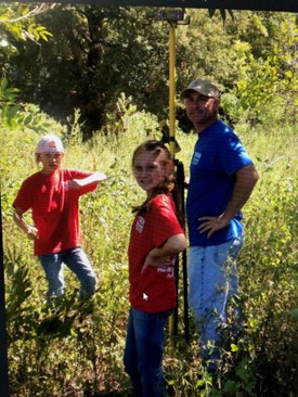 Patrick with his kids out surveying